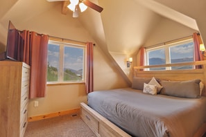A bedroom with a bed, a dresser, a window, and a ceiling fan. - Secluded private home with incredible views (Silverthorne)
