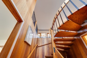 A wooden staircase with a metal railing, leading to an upper floor. - Sunset Port at Heceta Beach *Great Views* (Florence)