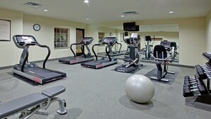 A gym with treadmills, a bench, a large exercise ball, and weight machines. - Accessible Suite | Roll-In Shower | Free Breakfast (Elkhart)