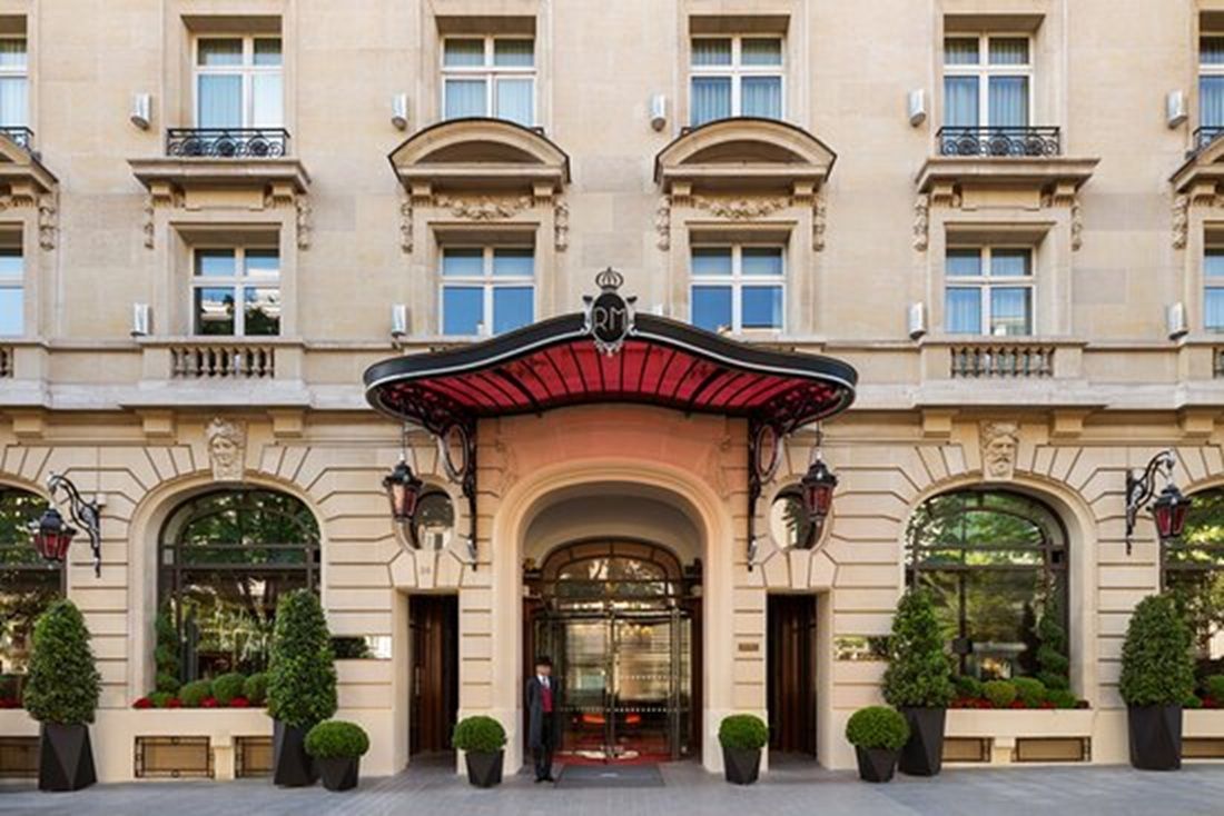 A classical building facade with a central entrance, large windows, and symmetrical design.