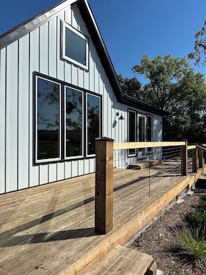 A modern building with large windows and a wooden deck. - Historic Weston Farmhouse - Private Countryside Escape (Weston)
