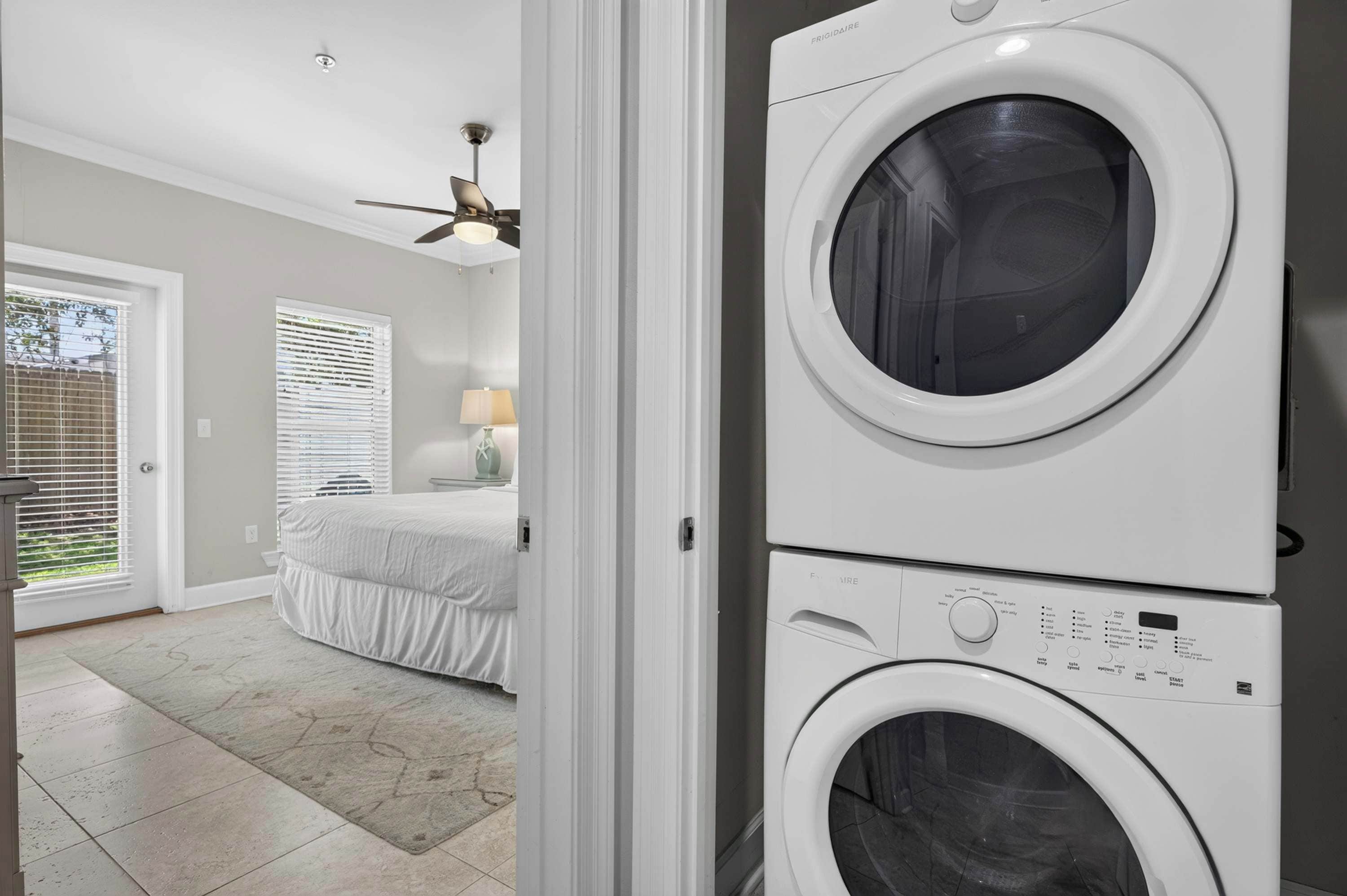 A laundry room with two stacked front-loading washing machines.