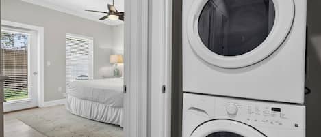 A laundry room with two stacked front-loading washing machines.