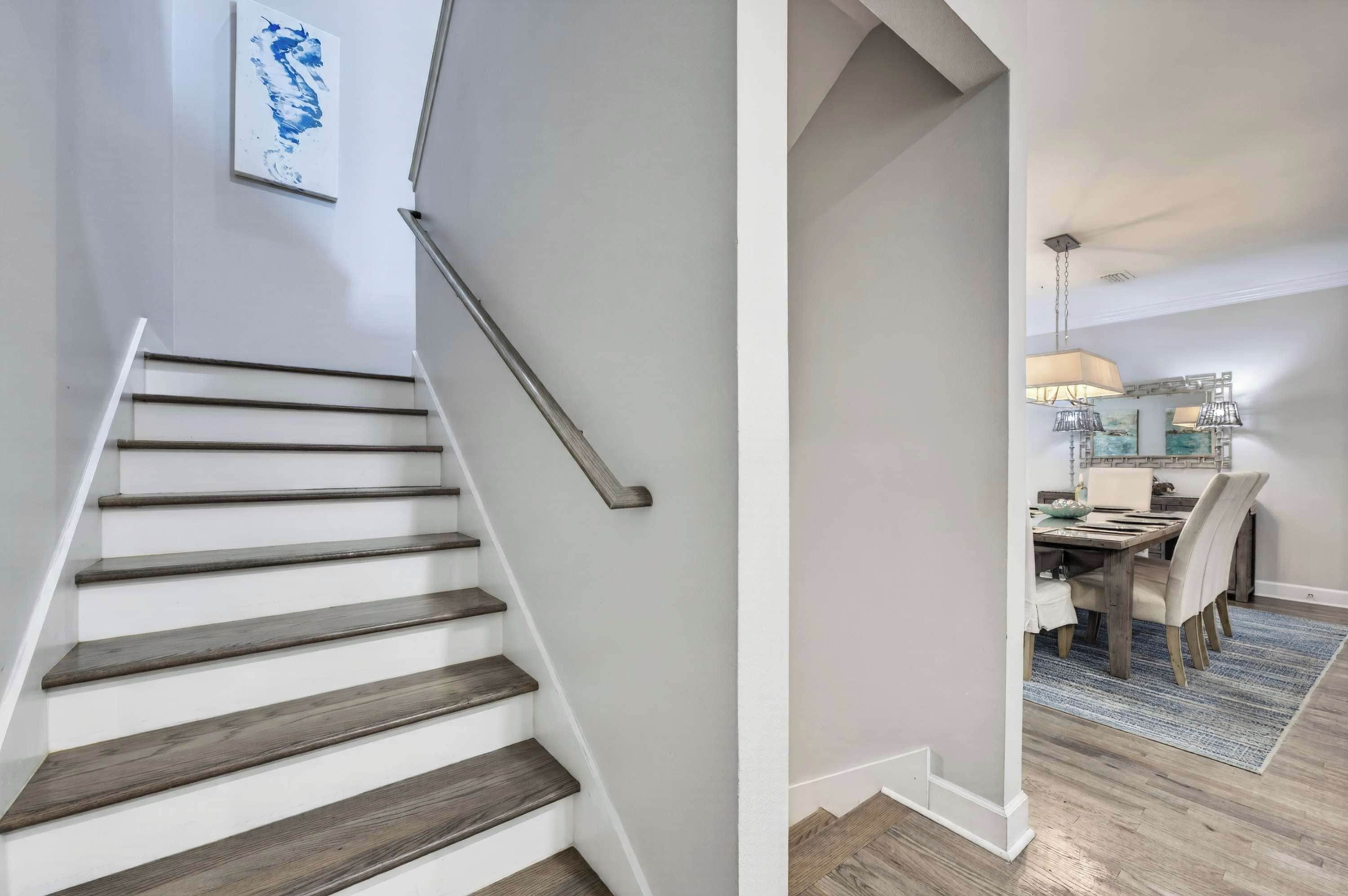 A staircase with wooden steps and a modern light fixture.