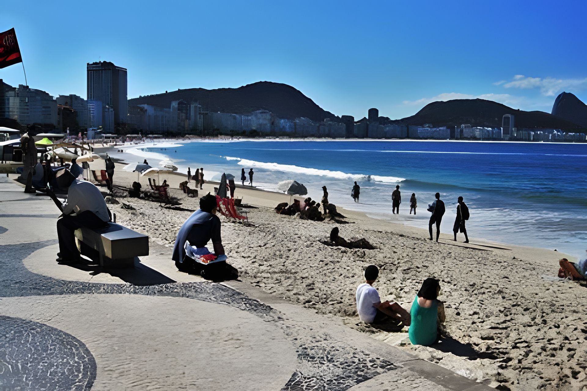 A beach with people relaxing and walking along the shore.