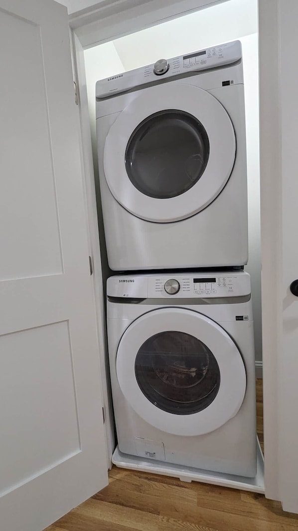 A white door with a built-in washer and dryer unit.