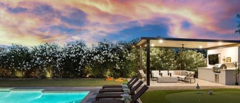 Resort-style backyard with pool, putting green & sunset lounge area