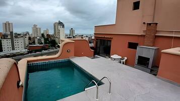 A rooftop pool with a view of the cityscape.