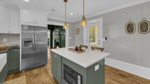 A kitchen with a central island, stainless steel appliances, and pendant lighting. - The Eddie At Mount Carmel- Peaceful, Sleeps 4 (Monroe)