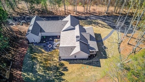 A large, multi-sectioned house with a spacious backyard, surrounded by trees. - The Retreat at Mount Carmel-Peaceful Sleeps 6 (Monroe)