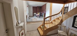 A staircase with a wooden handrail leading to a landing. - Gleenbach Vacation Home with a Balcony (Kirtorf)