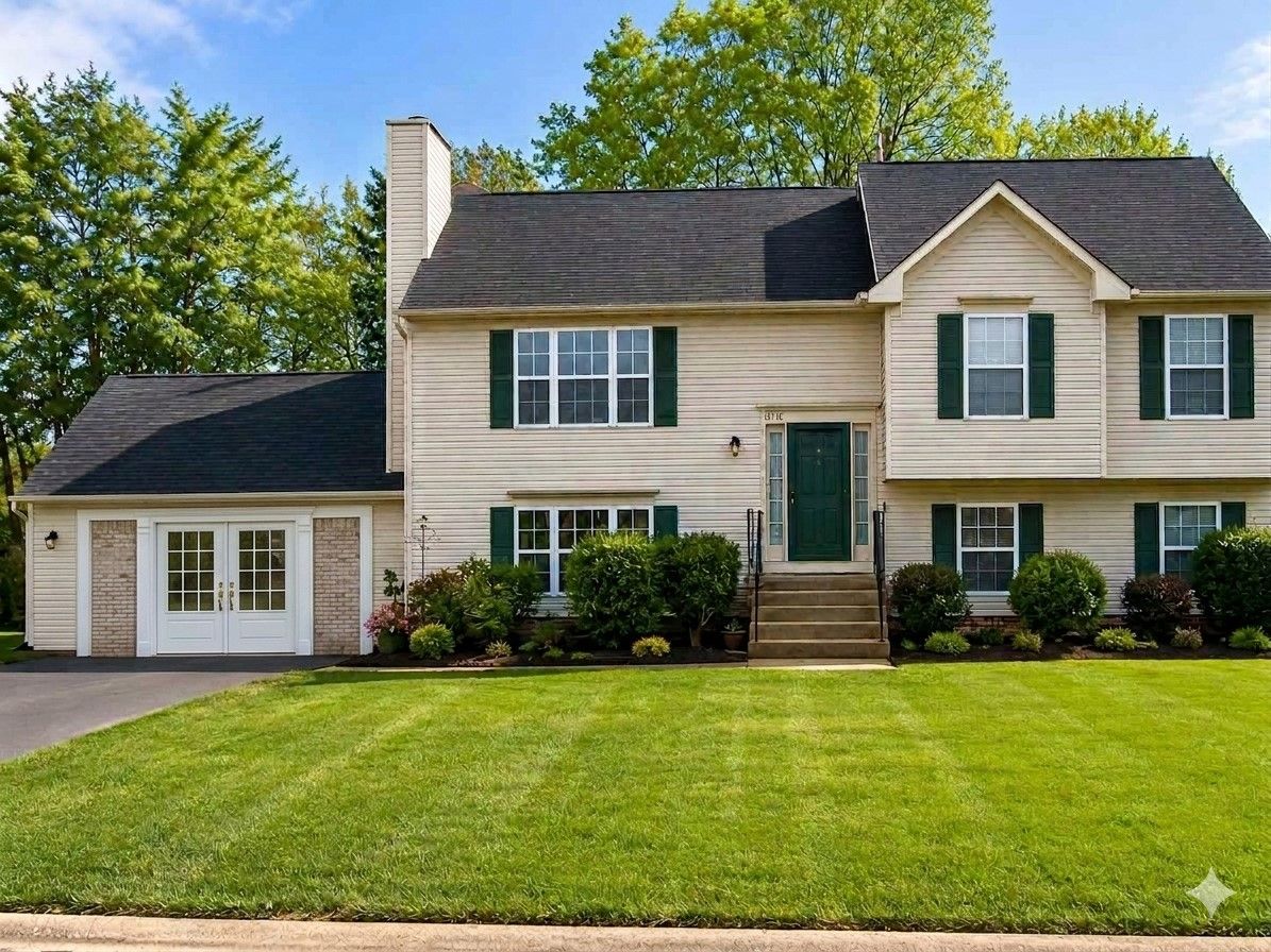 A two-story house with a front entrance, a garage, and a well-maintained lawn.