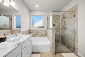 A modern bathroom with a glass-enclosed shower, a bathtub, and a vanity with a mirror. - Comfort Meets Space - Feel Right at Home (Cypress)