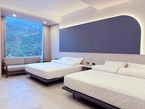 A hotel room with two beds, a sofa, a large window with curtains, and a modern ceiling design. - Xingwan (Kaohsiung City)