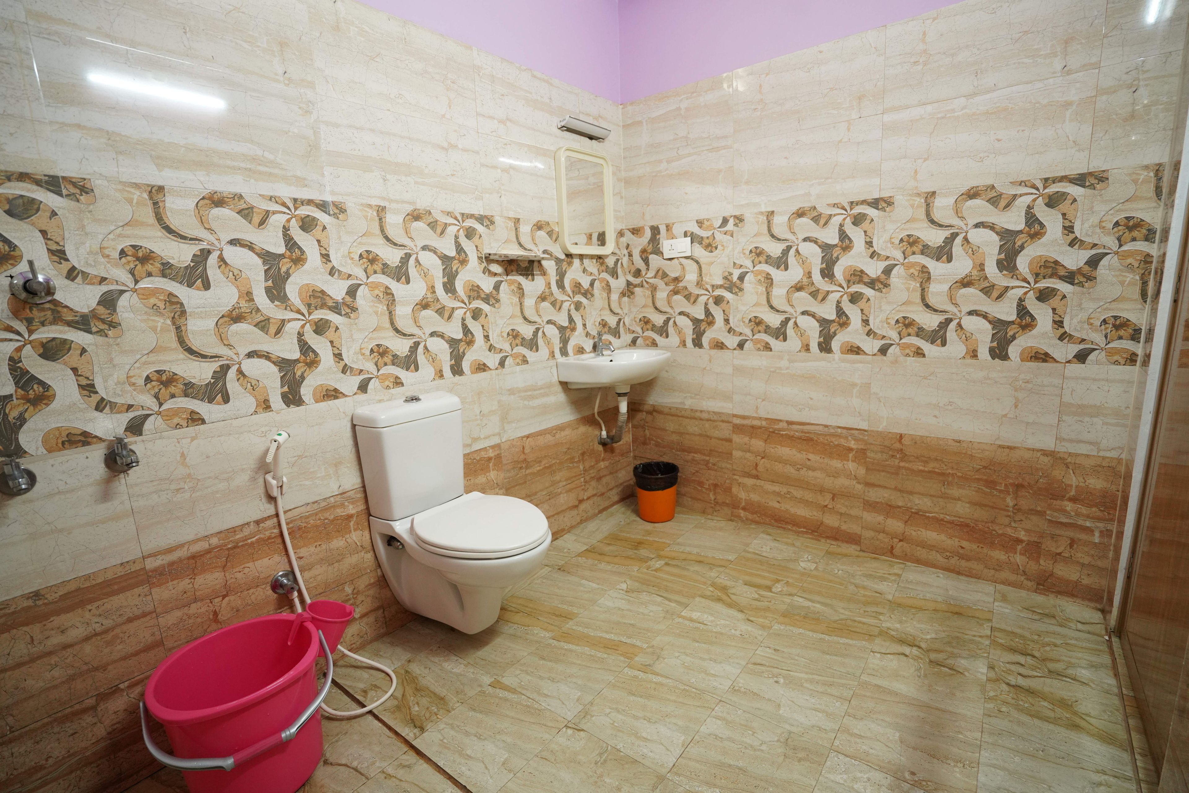 A bathroom with a toilet, sink, and shower area.