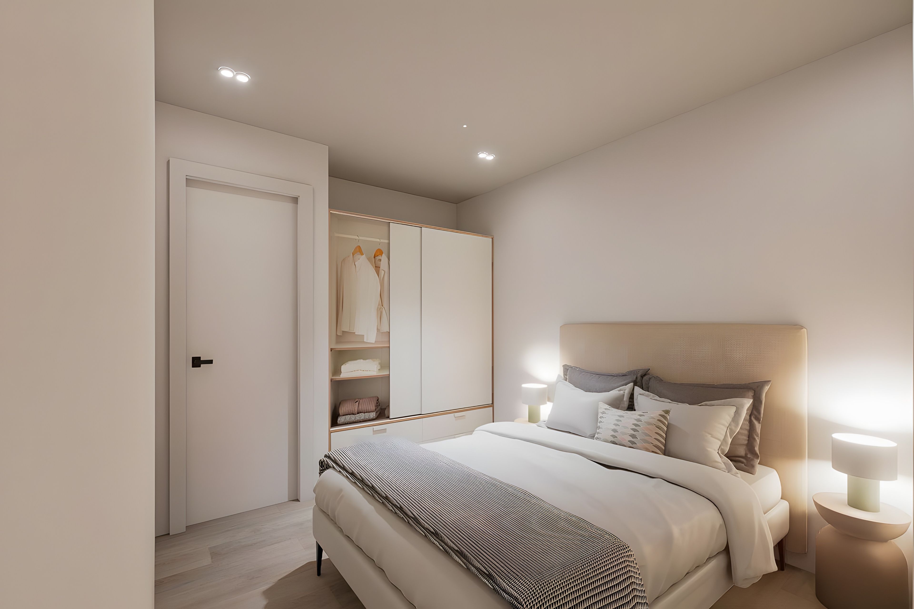 Una camera da letto moderna con un letto, lampade da comodino, un armadio e un tavolino.