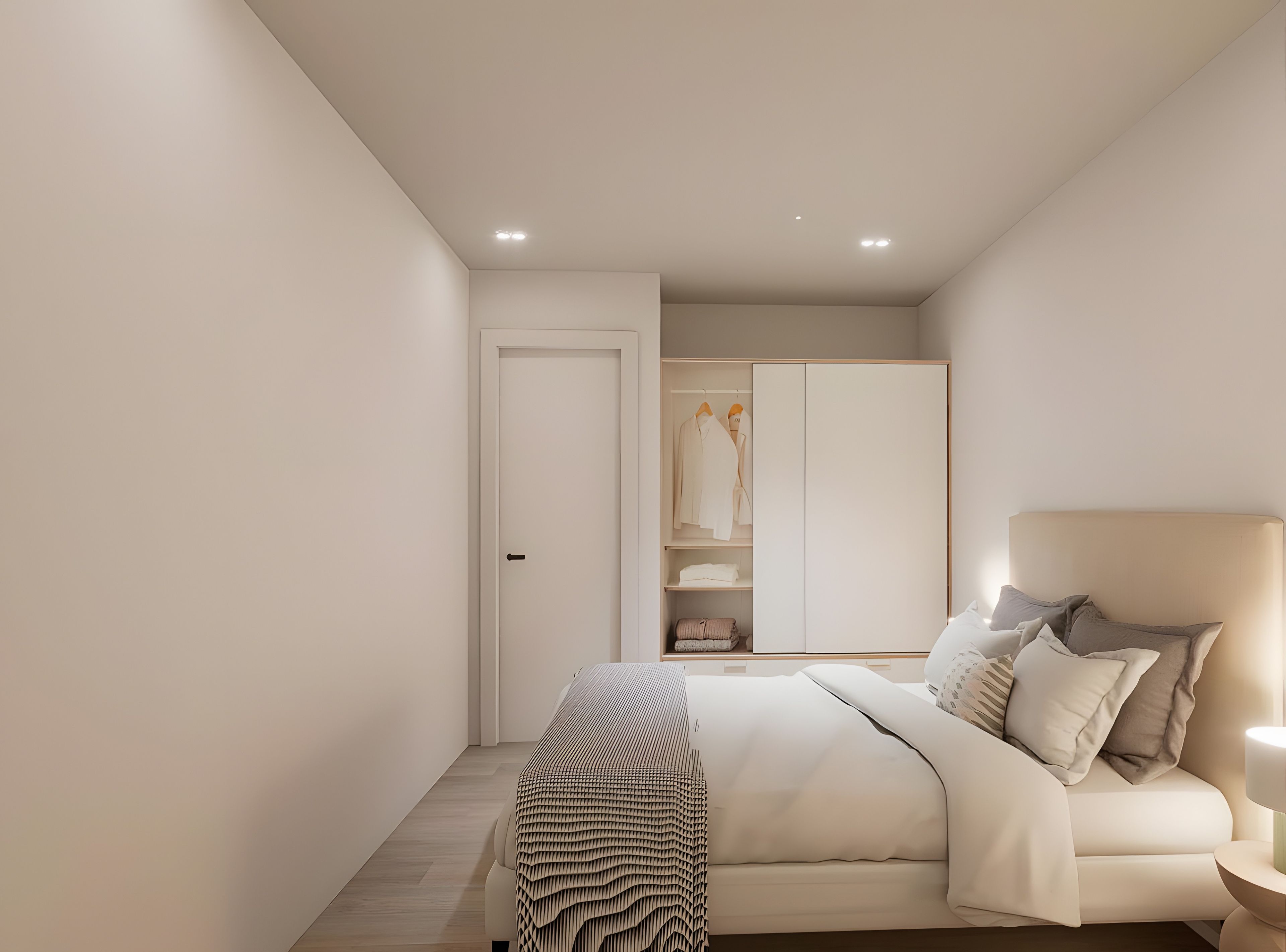 A modern bedroom with a bed, bedside table, and a wardrobe.