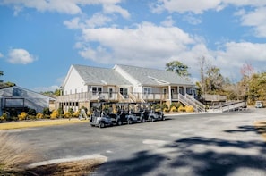 A large building with multiple balconies and a covered walkway, likely a hotel or resort. - Marina View Townhome Overlooking Northwest Creek Marina (New Bern)