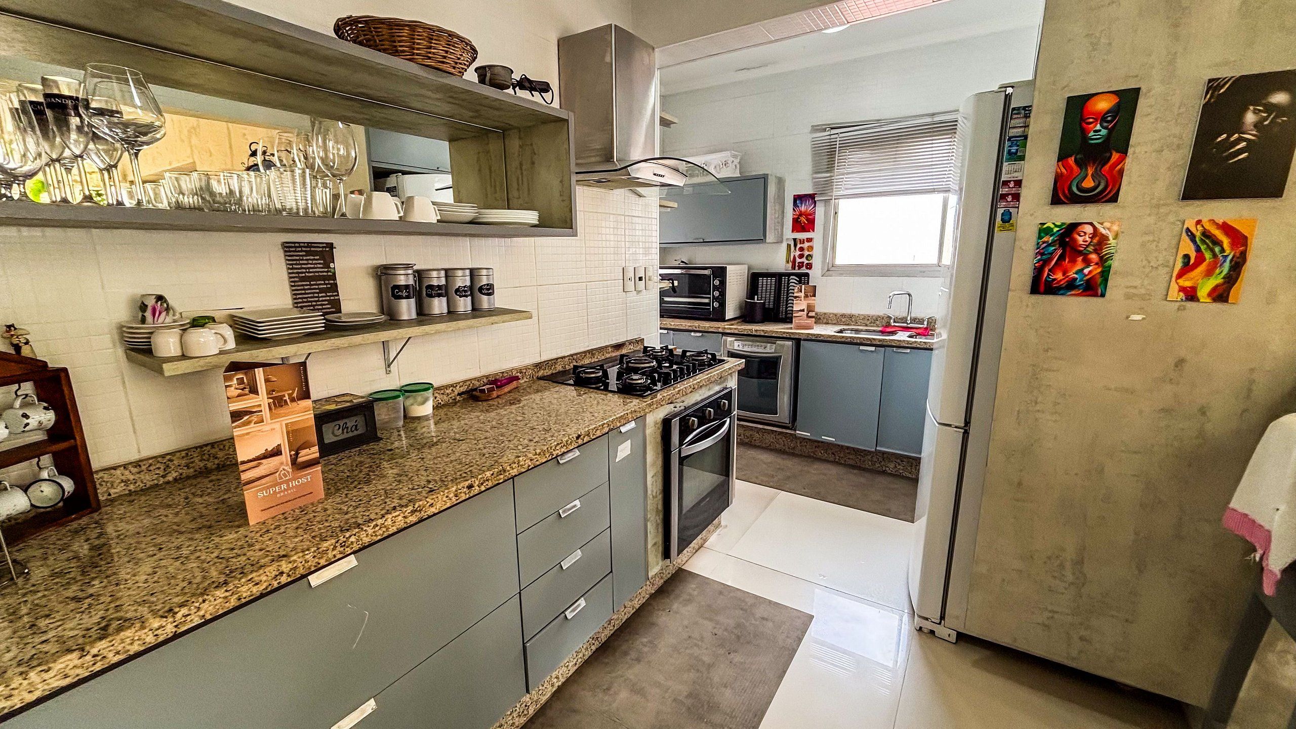 A modern kitchen with granite countertops, stainless steel appliances, and a built-in oven.