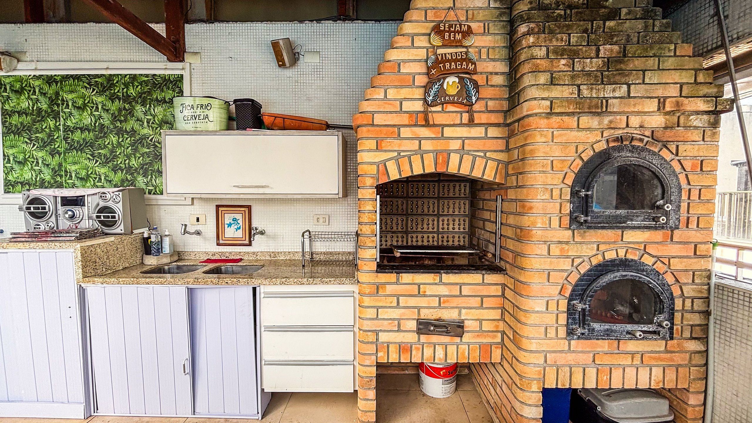 Una cocina con horno de ladrillo, un lavamanos y una encimera.