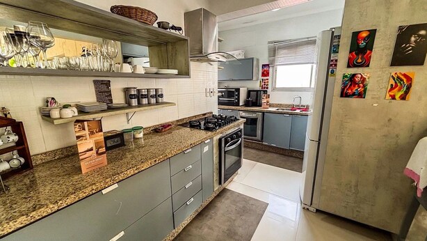 A modern kitchen with granite countertops, stainless steel appliances, and a built-in oven.