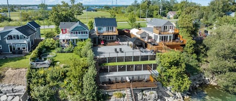 A residential area with houses, a dock, and a clear view of the water.