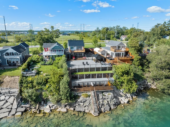 A residential area with houses, a dock, and a clear view of the water.