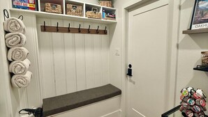 A hallway with a bench, a basket, a shelf with items, and a door. - Luxury Camper Van Parking - 16 miles to Yosemite 5 miles to Bass Lake! #3 (Oakhurst)
