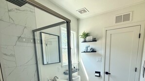A bathroom with a glass-enclosed shower, a toilet, a sink, and a mirror. - Luxury Camper Van Parking - 16 miles to Yosemite 5 miles to Bass Lake! #3 (Oakhurst)
