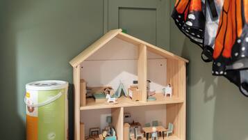 Una casa de muñecas con cocina, comedor y un dormitorio pequeño.