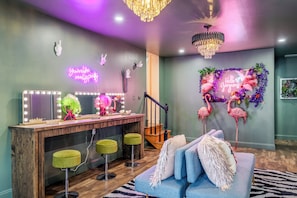 A room with a vanity area, a staircase, and a seating area with a decorative wall. - Neon & Pop Retro Cabin w/ Sauna and Hot Tub 






Neon & Pop (East Stroudsburg)