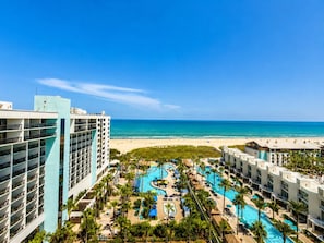 A resort with a pool area, beachfront, and high-rise buildings. - Sapphire 1104 - By GISO Vacation Rentals (South Padre Island)