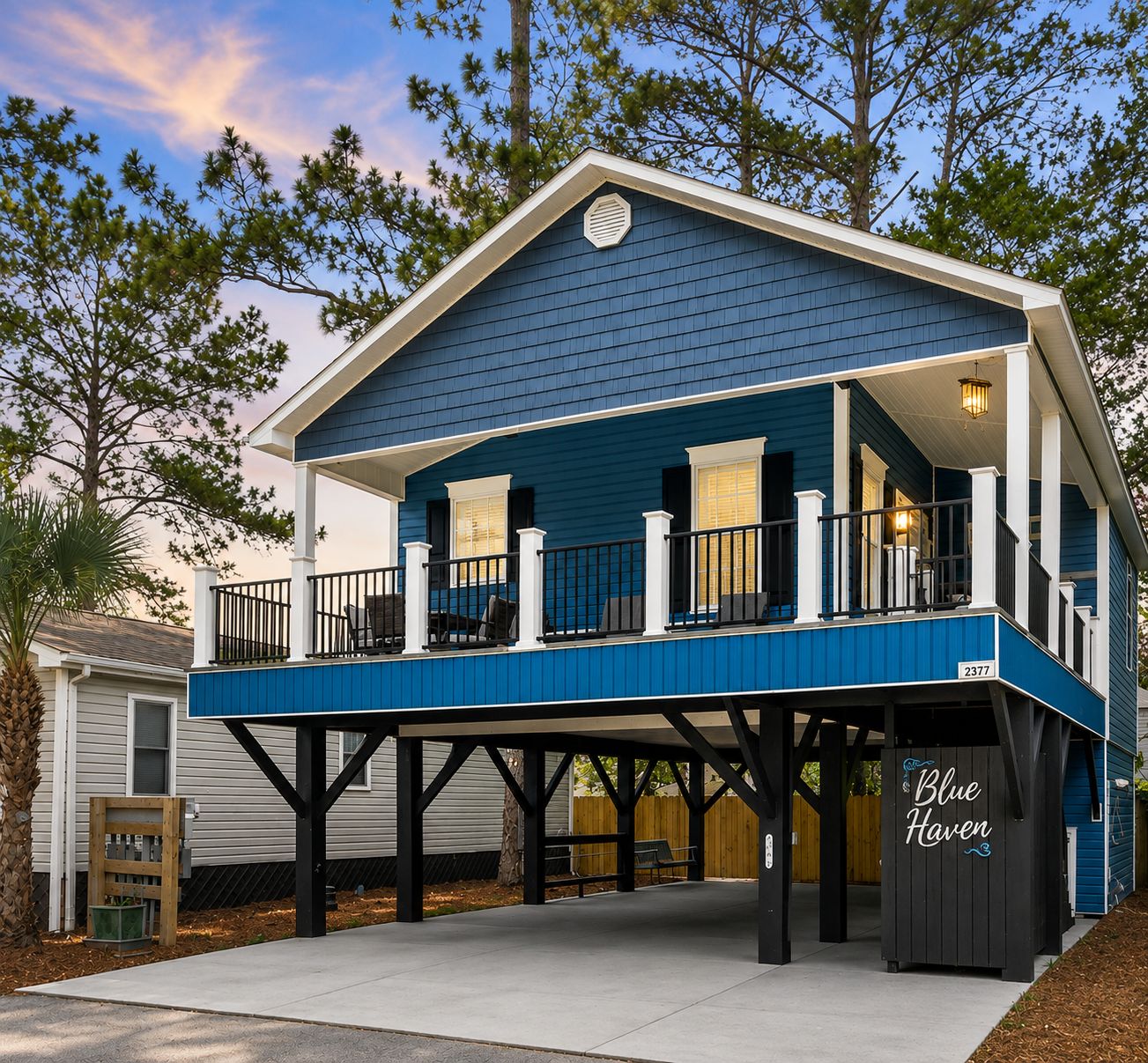 A two-story house with a balcony, a covered porch, and a small deck.