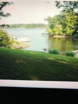 A view of a lake with a grassy area in the foreground. - Our Lake Wylie, SC 4BR/2BA waterfront House, sleeps 6 max., pier & dock. (Clover)