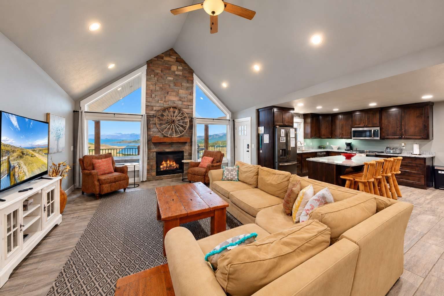 A spacious living area with a fireplace, a large sofa, and a television.