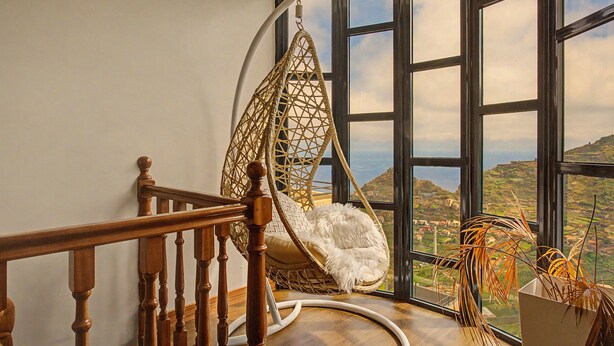 A wooden staircase leading to a room with a large window overlooking a landscape. - Holiday Home 'Vista Atlântica Garachico' with Sea View, Private Terrace & Wi-Fi (Câmara de Lobos)
