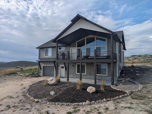 A two-story house with a balcony, a garage, and a landscaped front yard. - The Bear Lake Spot - Lake Views & Wet Bar (Garden City)