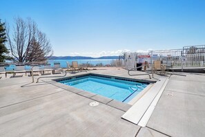 A rectangular pool with a clear blue water surface, surrounded by a concrete deck. - Puzzled at Bear Lake (Garden City)