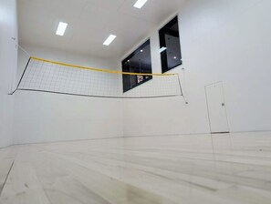 A squash court with a net, walls, and a door. - Raspberry Ridge Lodge - Lake Views & Indoor Court (Fish Haven)