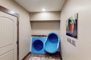 A laundry room with a washing machine and a blue drying rack. - Raspberry Ridge Lodge - Lake Views & Indoor Court (Fish Haven)