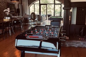 A room with a foosball table, a billiards table, and a fireplace. - Renovated Cévennes-style house – heated pool in the forest (Les Plantiers)