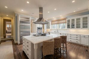 A spacious kitchen with a large island, stainless steel appliances, and ample storage cabinets. - 61 River Marsh Lane, Kiawah Island (Kiawah Island)