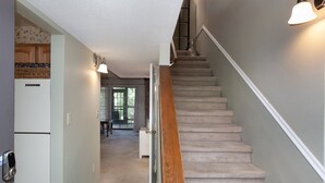 A staircase with a wooden handrail leading to a landing. - Smoky Laurel Cottage - Mountain Views & Fireplace! (Gatlinburg)