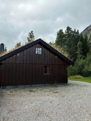 A wooden building with a sloped roof, a small window, and a number '39' on the side.