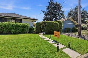 A well-maintained lawn with a pathway leading to a house. - Cascade & Sammamish: 180° Mountain & Lake Views (Bellevue)