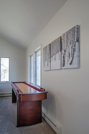 A pool table in a room with large windows and three wall-mounted artworks. - 4br House with Hot Tub + Sauna + Shuttle or Walk to Stratton! (Winhall)