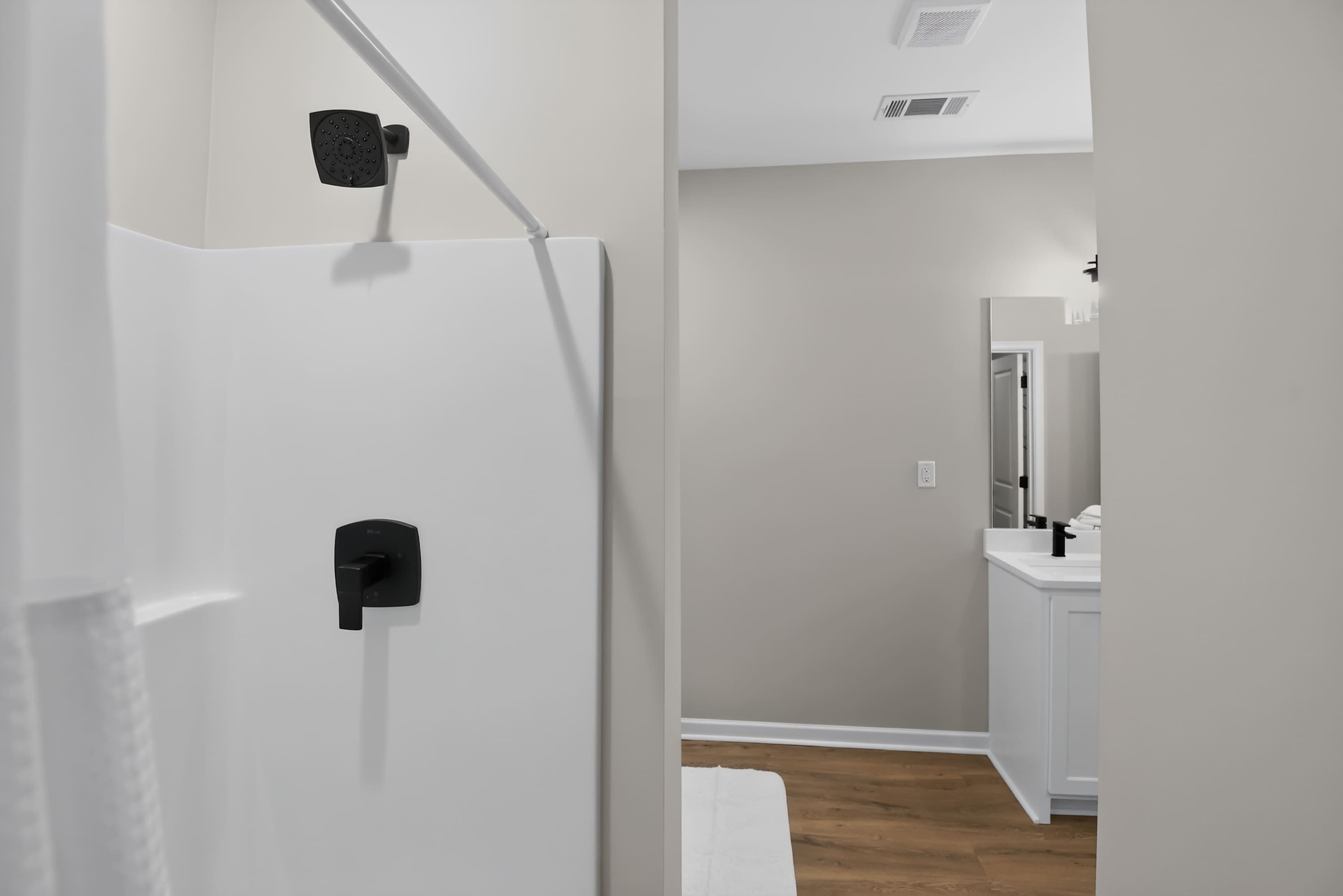 A bathroom with a shower, toilet, and sink.
