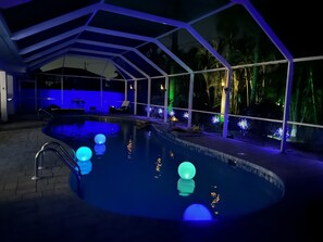 A pool area with a covered seating area and a view of the outdoors. - Cape Escape Oversized Pool Home in coveted Cape Harbor area of Cape Coral (Cape Coral)
