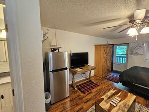 A compact living space with a kitchenette, a television, a ceiling fan, and a wooden cabinet. - Delightful NEW listing, freshly remodeled,Bayfield perfect for relax & adventure (Bayfield)