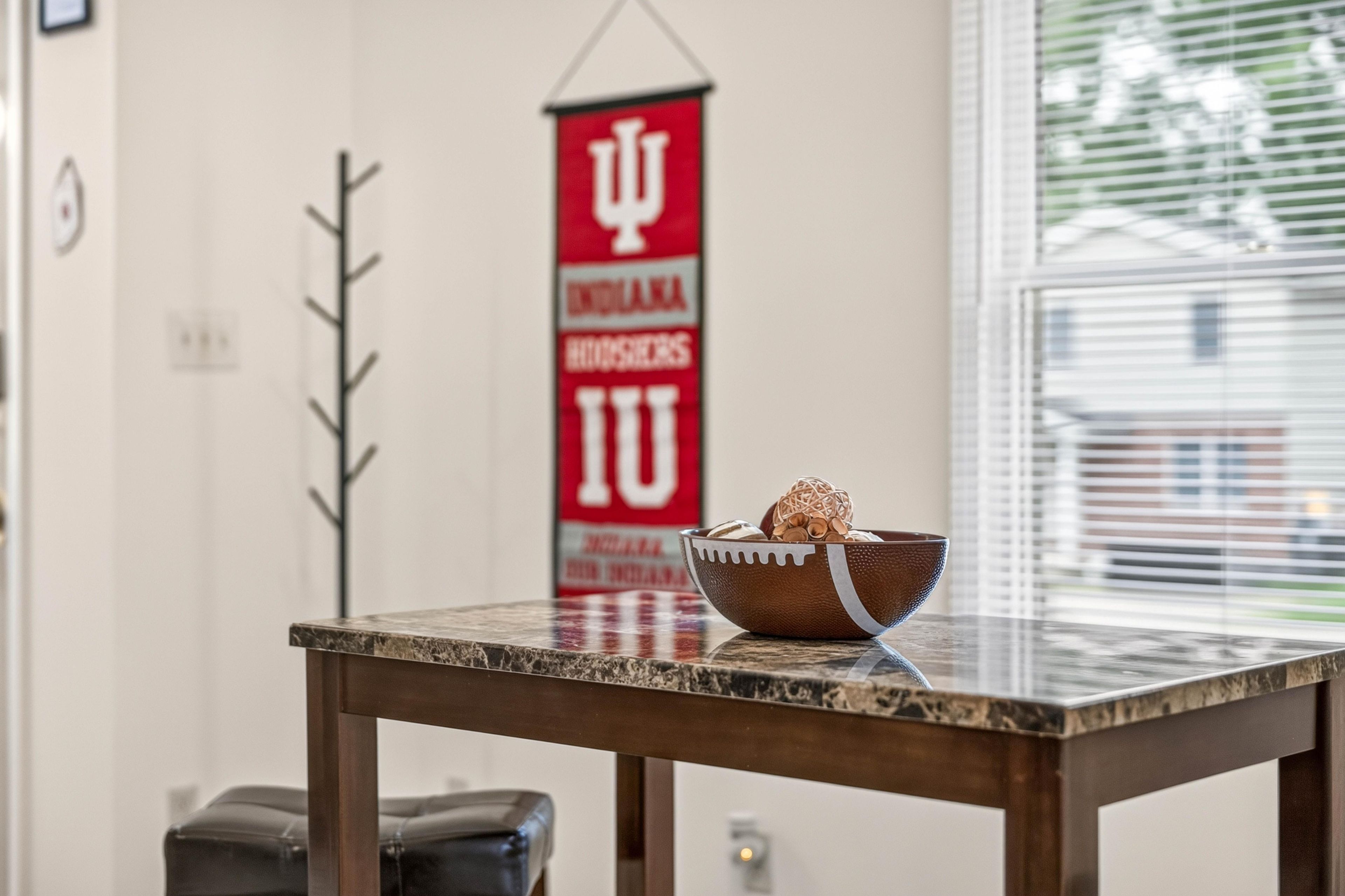 A marble table with a bowl of food and a red banner with white lettering in the background.